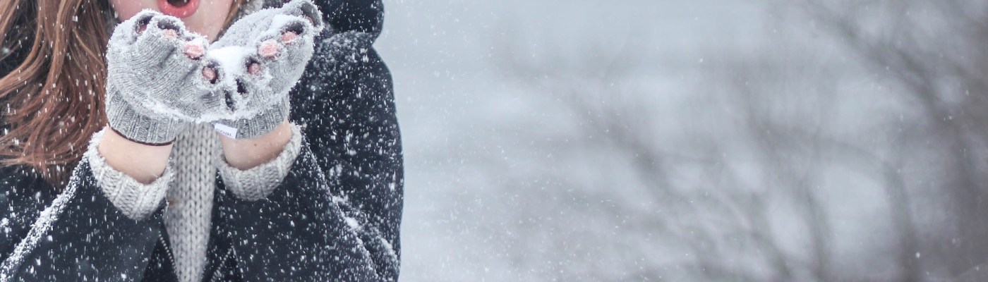 girl blowing snow